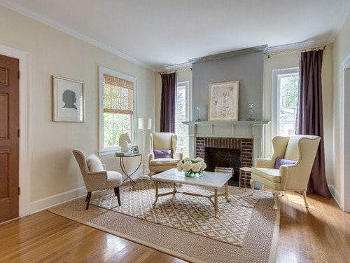Living-room-fireplace-surround-painted-a-pale-with-dusty-blue-rich-buttercream-white-trim-walls