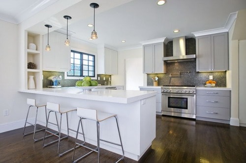 Contemporary-two-tone-kitchen-design-with-white-kitchen-cabinets-and-peninsula-gray-kitchen-cabinets-white-quartz-countertops-black-mosaic-tiles
