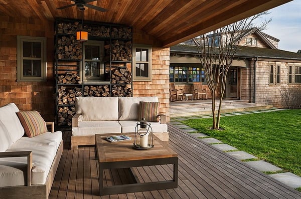 beach-style-porch-has-ample-space-for-outdoor-firewood-storage-shed